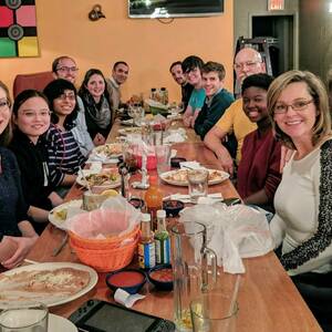 Lab members gather around table at Festivus dinner in 2018