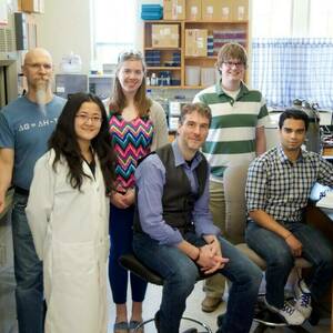 Lab members pose together in lab for group photo in 2014